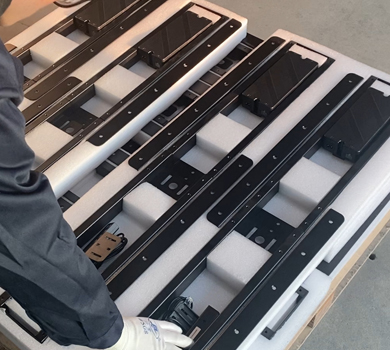 Multiple standing desk frames packed side by side, showcasing DELTA CAINA's streamlined packaging process for secure shipping and efficient global logistics